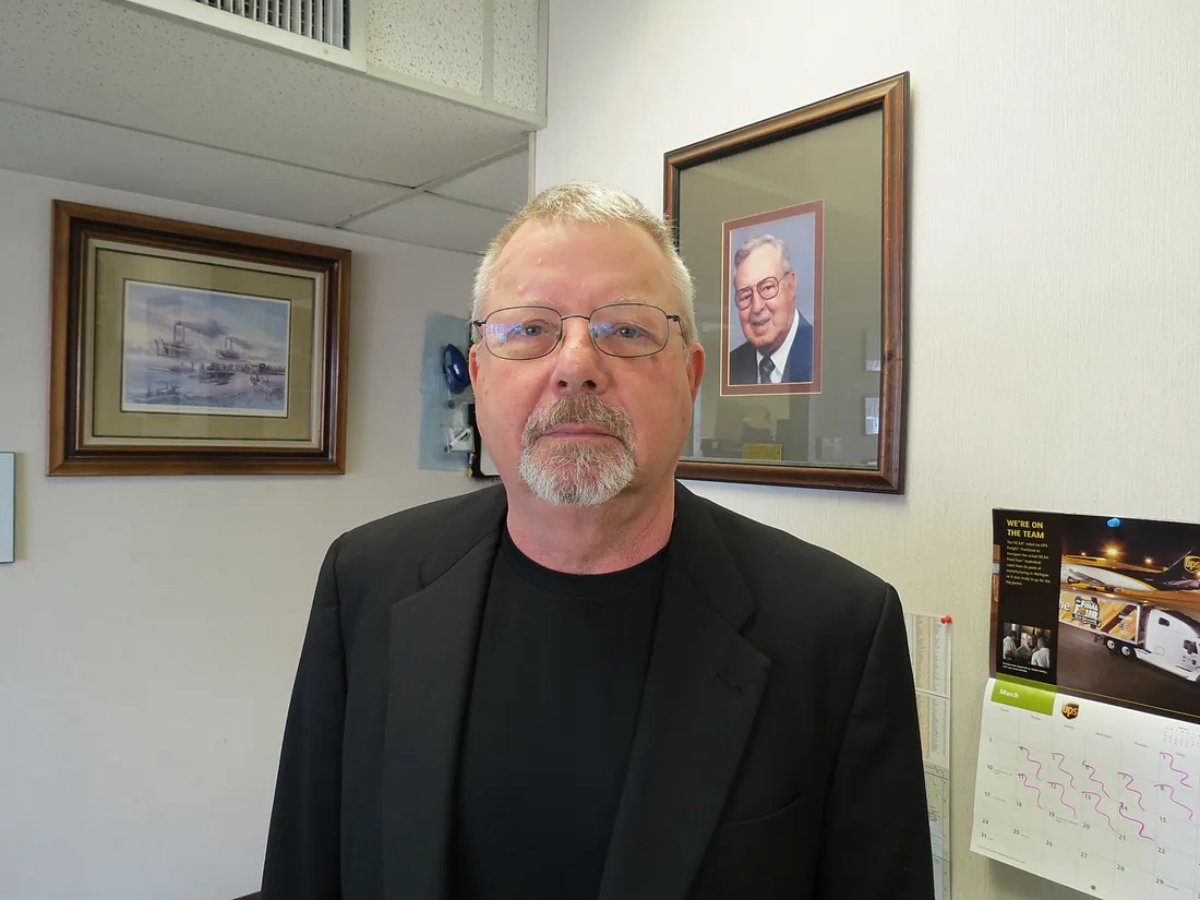 John Green at Green Marine, with a portrait of founder Algot Green behind him