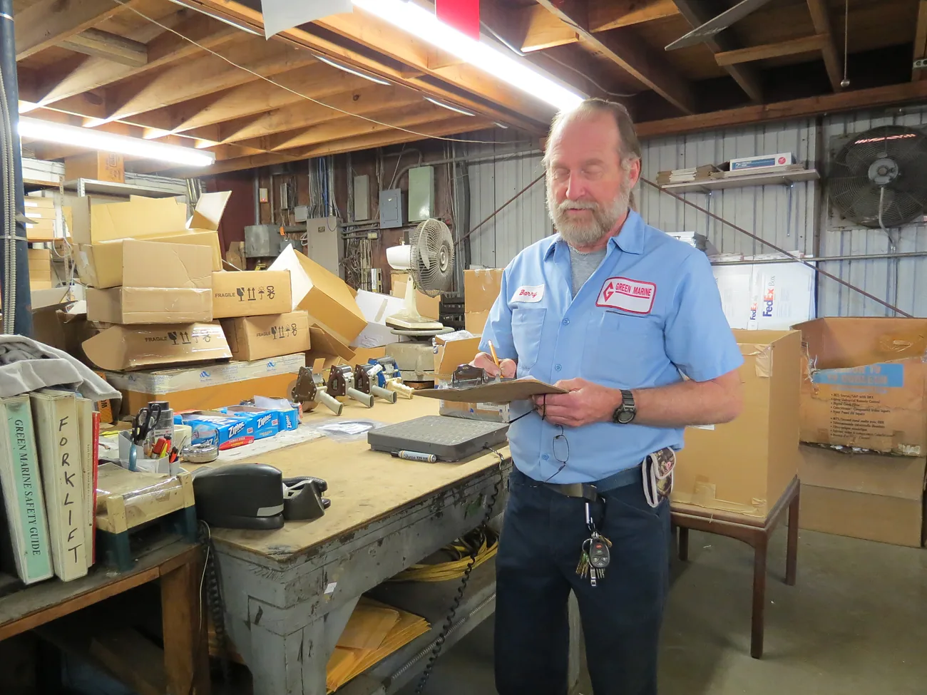 Checking a parts order at the Green Marine shipping bench