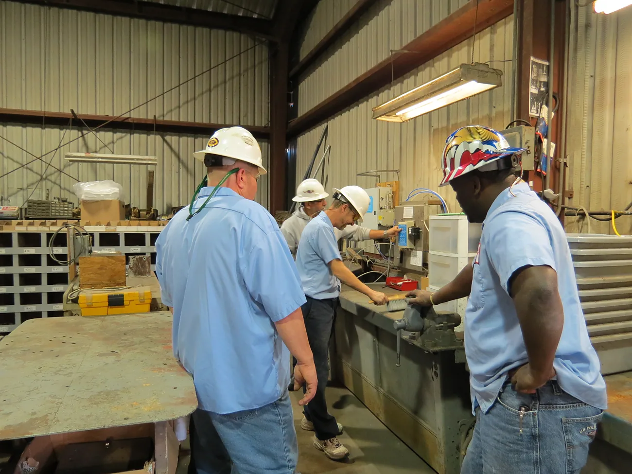 Green Marine technicians working at the shop bench